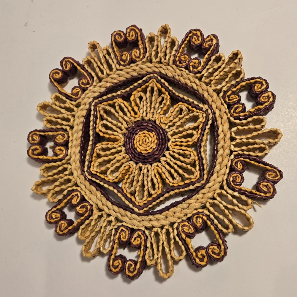 This charming vintage round trivet or hot pad is made of multicolor straw rattan